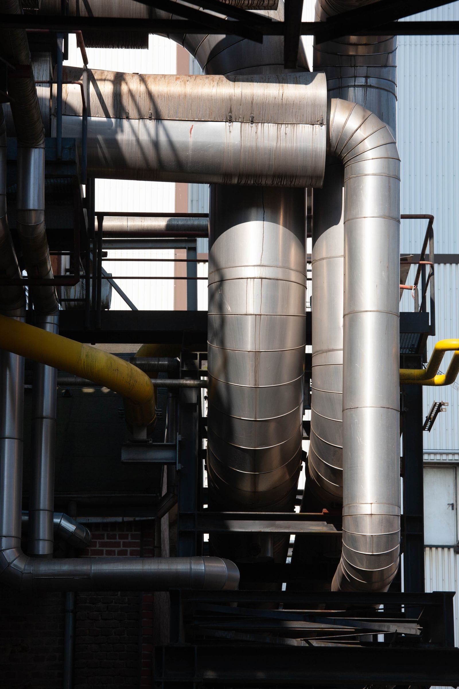 Stainless steel process columns and pipework at an industrial plant